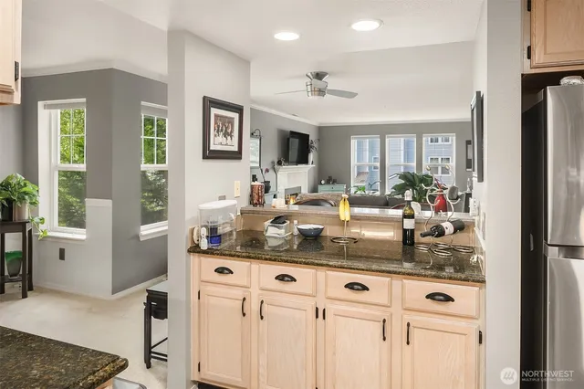 a kitchen with stainless steel appliances granite countertop a stove and a refrigerator