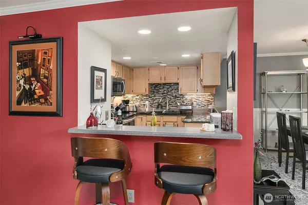 a kitchen with stainless steel appliances granite countertop a sink cabinets and wooden floor