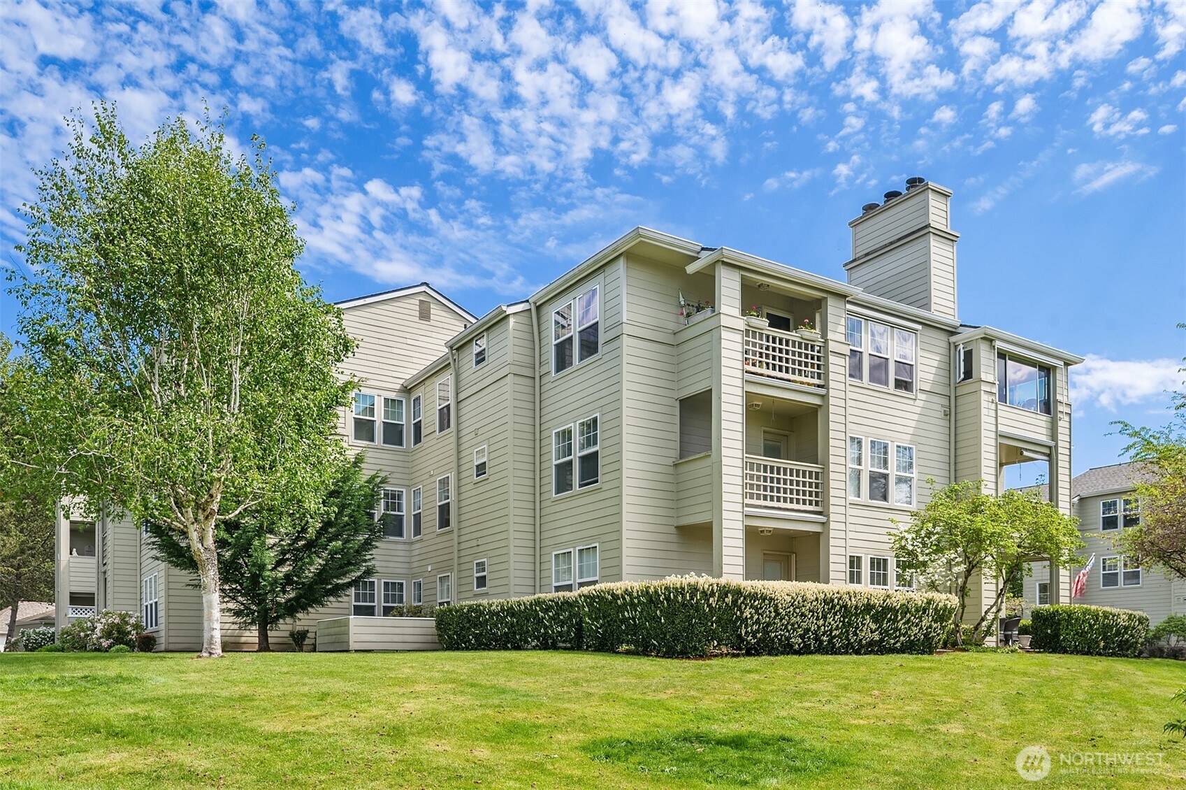 4109 224th Lane Southeast, Unit 213 Issaquah, WA 98029 - Photo 2 of 34 a front view of a building with a garden