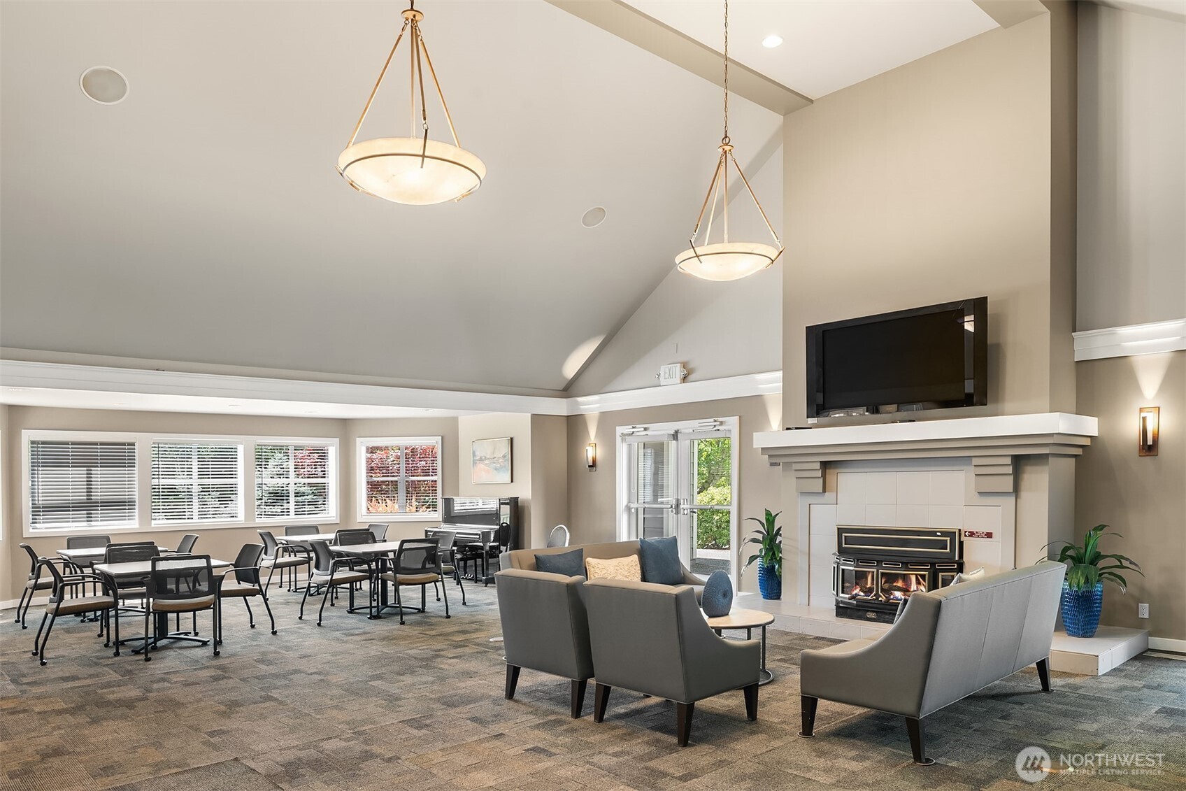 4109 224th Lane Southeast, Unit 213 Issaquah, WA 98029 - Photo 28 of 34 a living room with furniture a flat screen tv and a fireplace