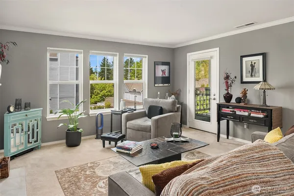 a bedroom with furniture and large windows