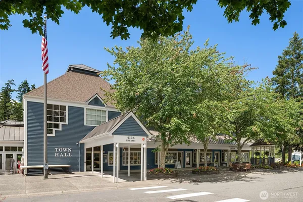a front view of a house with a yard and potted plants