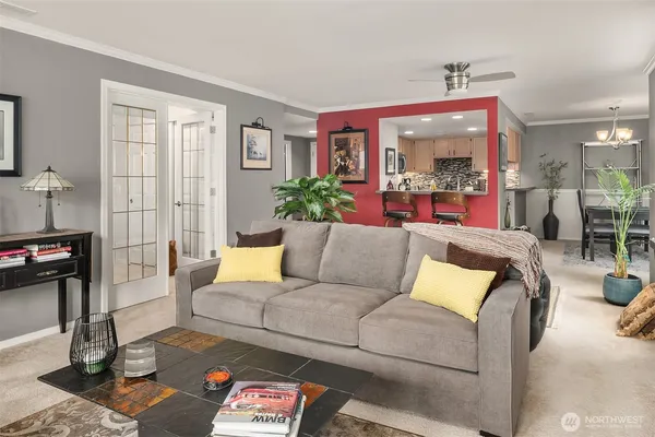 a living room with furniture and a floor to ceiling window