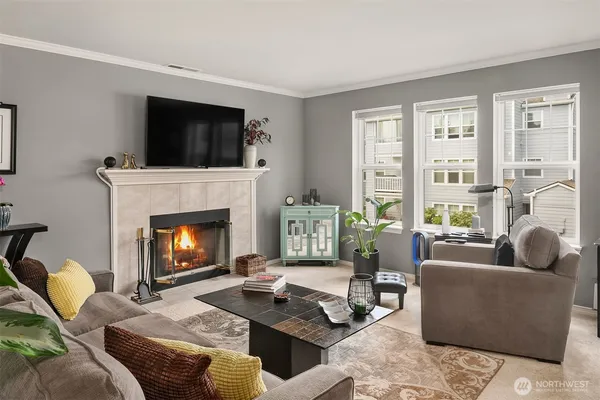 a living room with furniture a flat screen tv and a fireplace