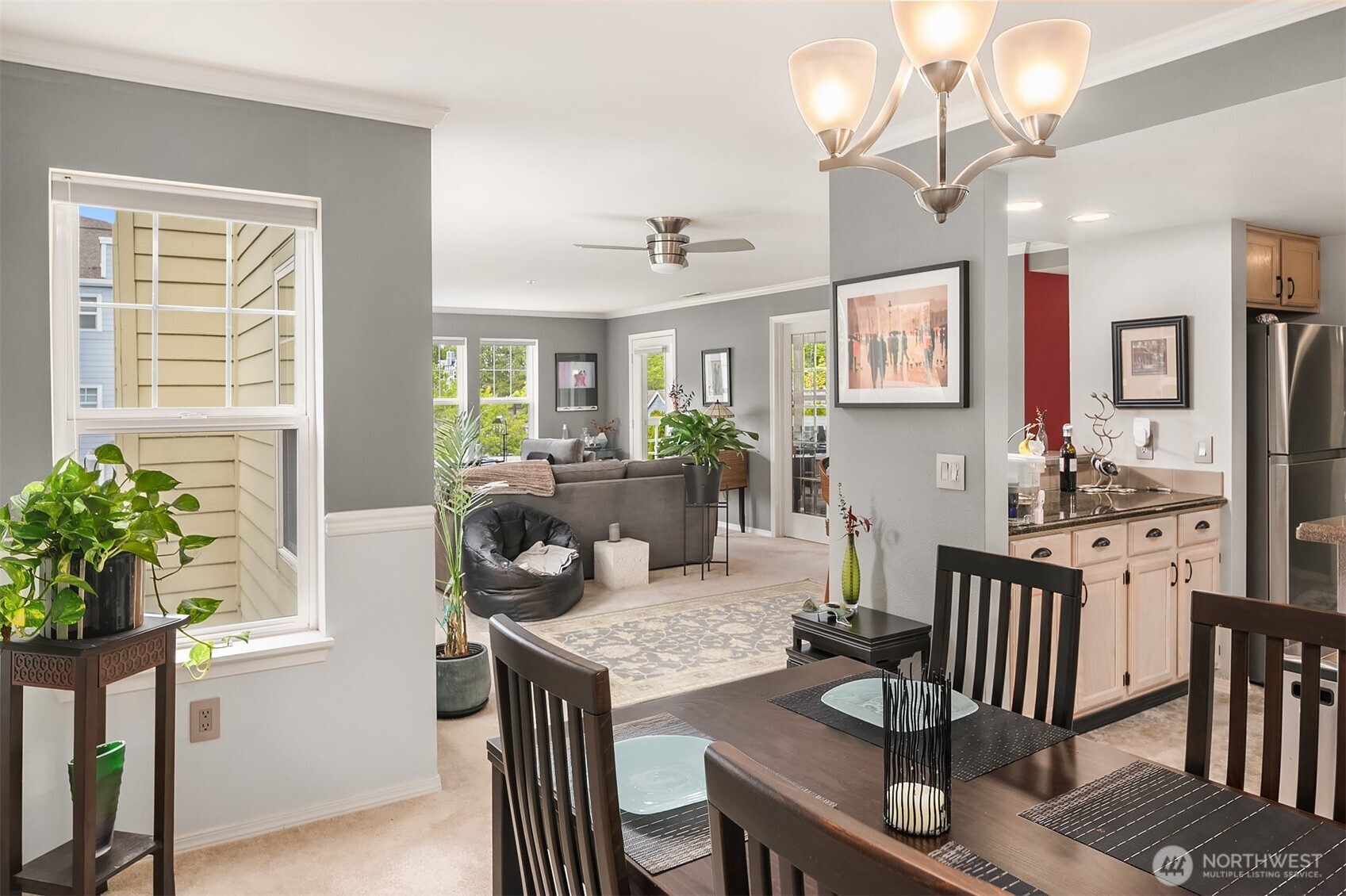 4109 224th Lane Southeast, Unit 213 Issaquah, WA 98029 - Photo 7 of 34 a view of a dining room with furniture a chandelier and wooden floor