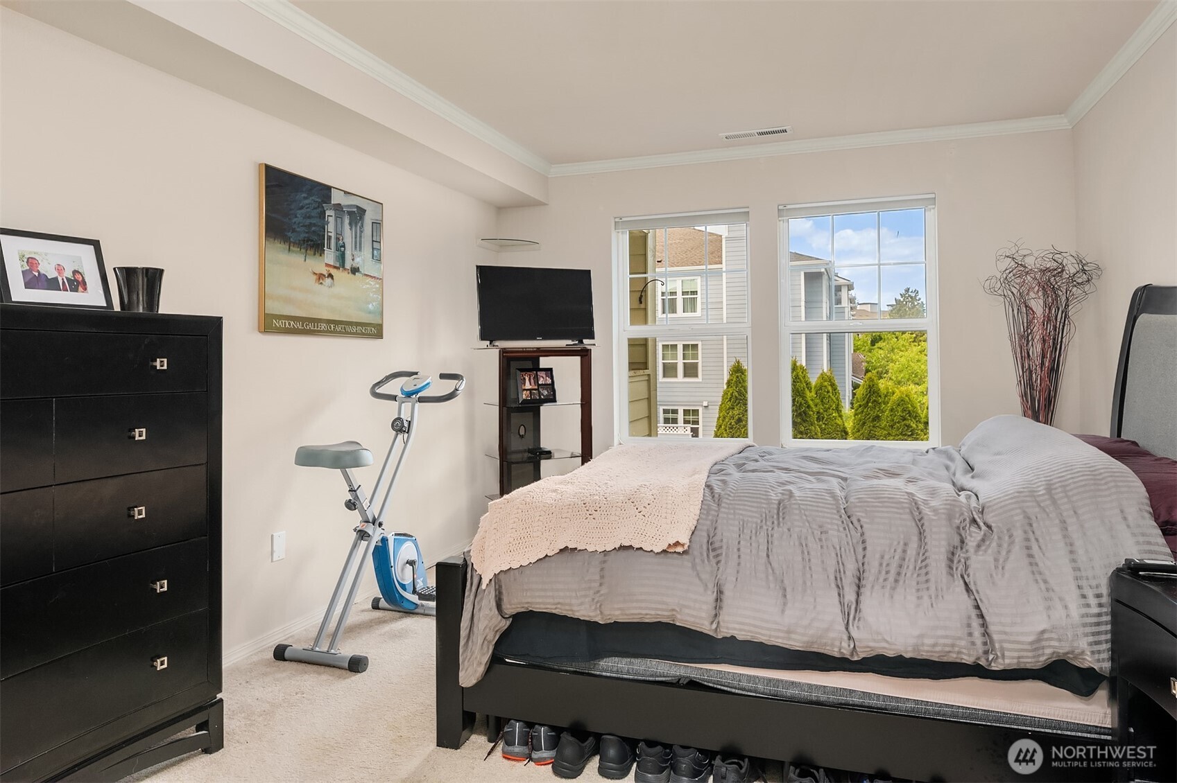 4109 224th Lane Southeast, Unit 213 Issaquah, WA 98029 - Photo 9 of 34 a bedroom with a bed and a flat tv screen on dresser