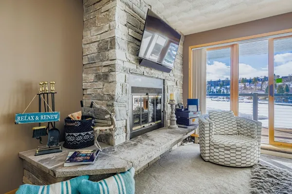 a living room with furniture a fireplace and a flat screen tv