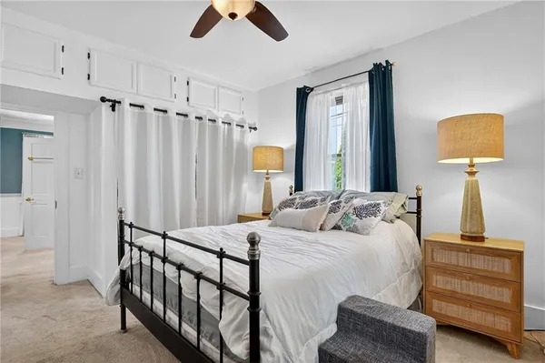 a bedroom with a bed a couch and a window