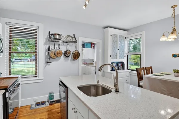 a kitchen with a sink cabinets and window