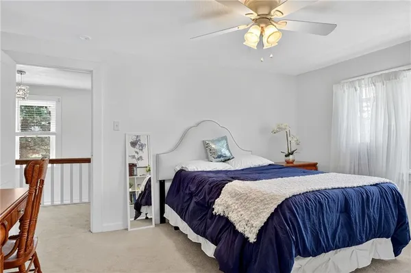 a bedroom with a bed a window and closet