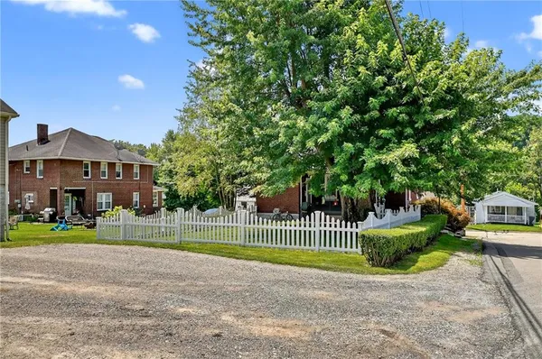 a front view of a house with a garden and plants