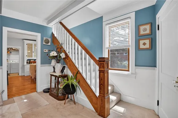 a view of entryway and hall with wooden floor