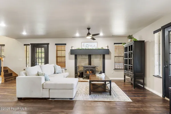 a living room with furniture wooden floor and a fireplace
