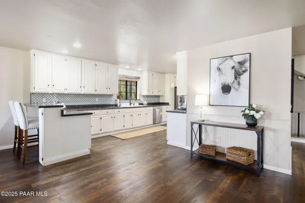 a kitchen with stainless steel appliances a stove a sink and a refrigerator