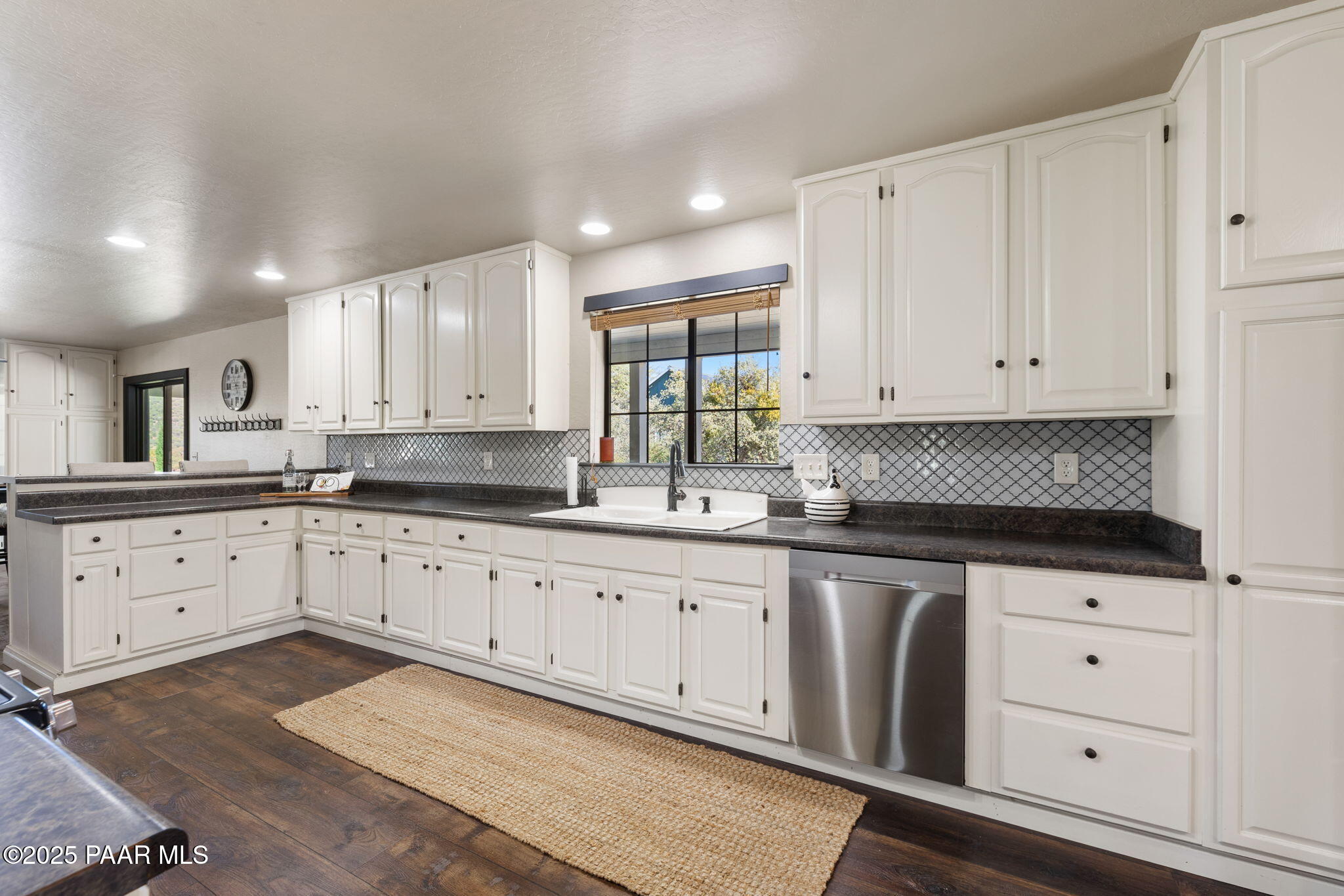 17441 West Fair Oaks Road Prescott, AZ 86305 - Photo 26 of 47 a kitchen with granite countertop white cabinets white stainless steel appliances with a sink and dishwasher