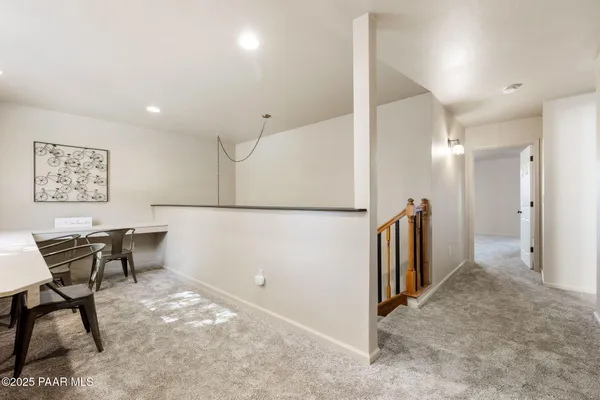a view of a hallway with seating area