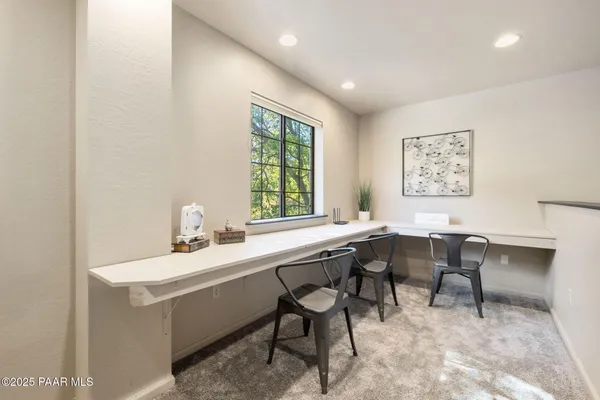 a dining room with a table and chairs