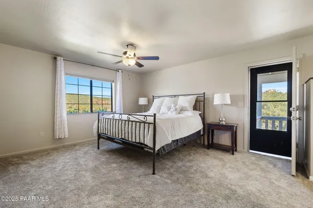 a spacious bedroom with a bed and a table