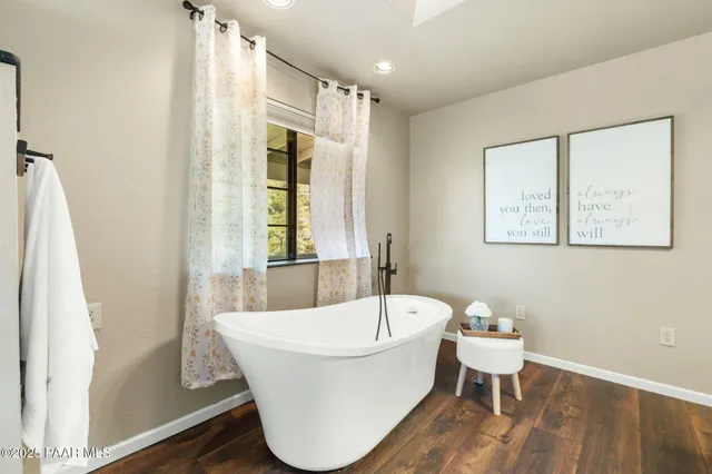 a white bath tub sitting next to a white toilet