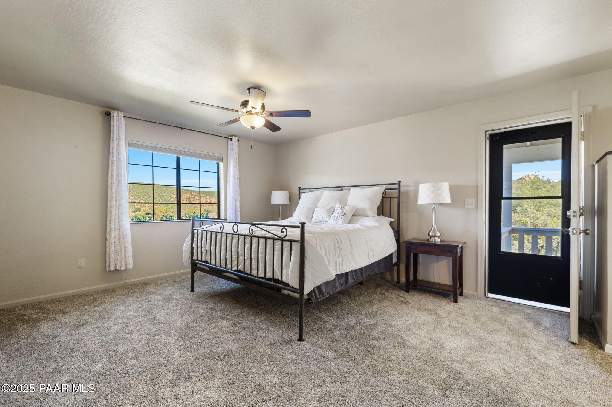 17441 West Fair Oaks Road Prescott, AZ 86305 - Photo 33 of 47 a spacious bedroom with a bed and a table