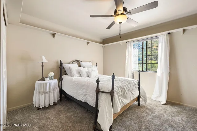 a spacious bedroom with a bed and a chandelier