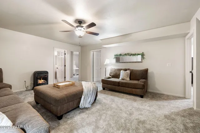 a living room with furniture and a ceiling fan