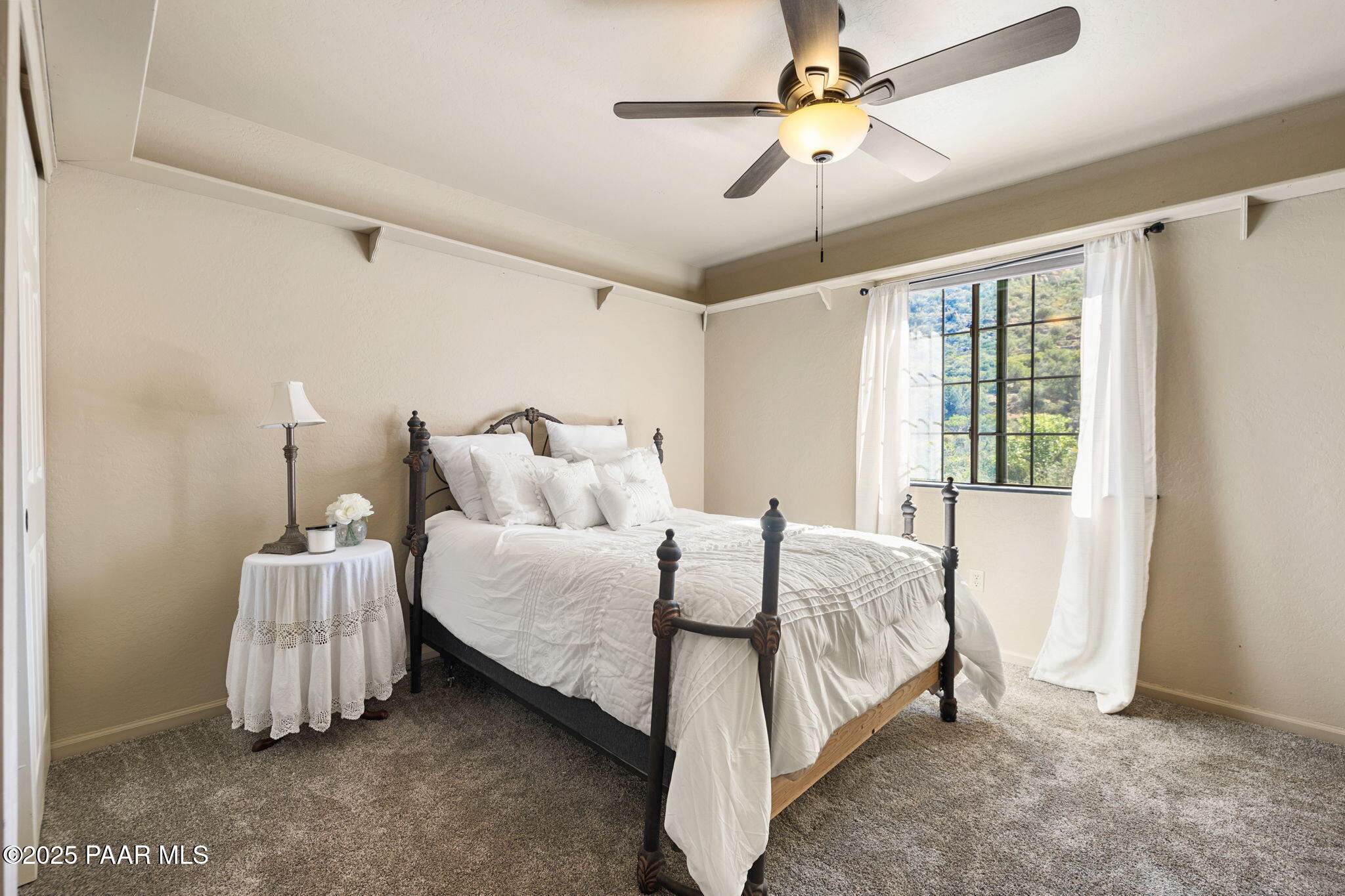 17441 West Fair Oaks Road Prescott, AZ 86305 - Photo 36 of 47 a spacious bedroom with a bed and a chandelier