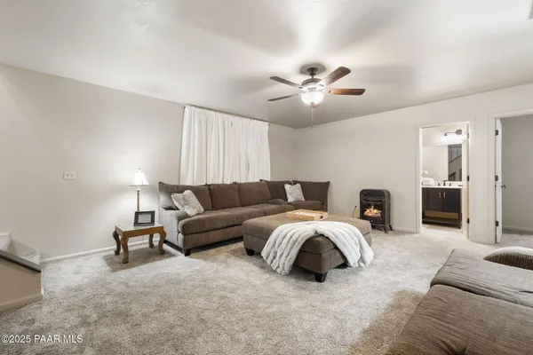 a living room with furniture and a ceiling fan