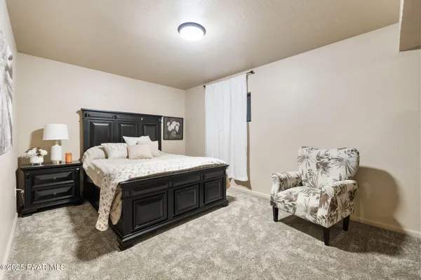 a bedroom with a bed and a couch