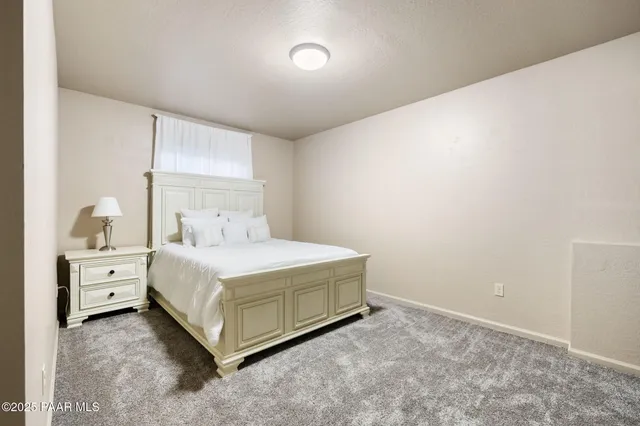a spacious bedroom with a bed and a cabinets