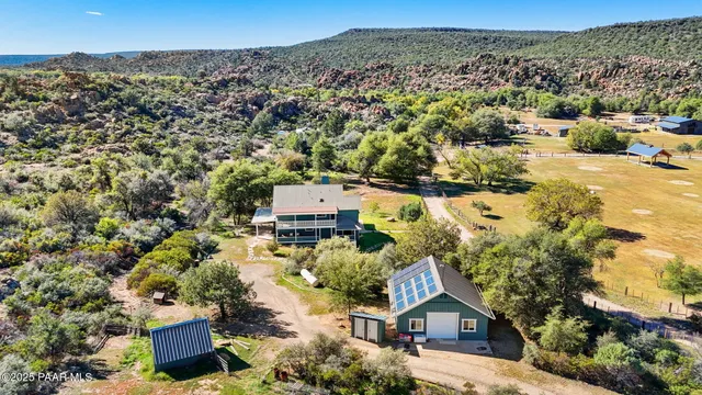an aerial view of a house with a yard