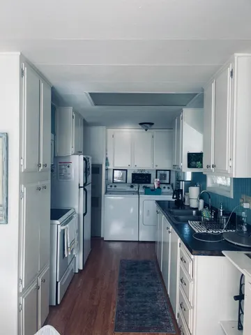 a kitchen with stainless steel appliances a refrigerator sink and wooden cabinets