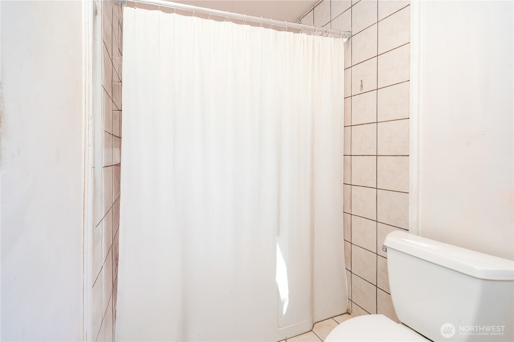 251 Arden Street Port Hadlock, WA 98339 - Photo 15 of 20 a white toilet sitting next to a shower curtain