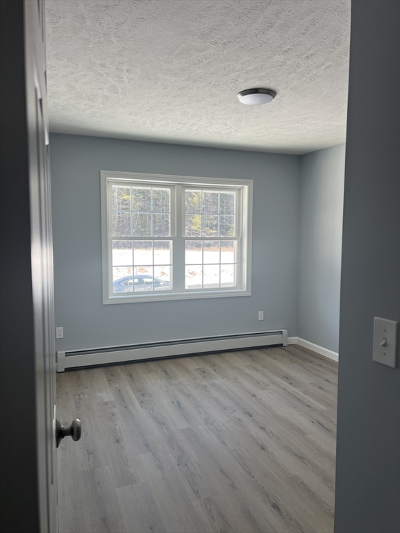 246 Holtshire Road, Unit LOT 3 Orange, MA 01364 - Photo 11 of 16 an empty room with wooden floor and windows