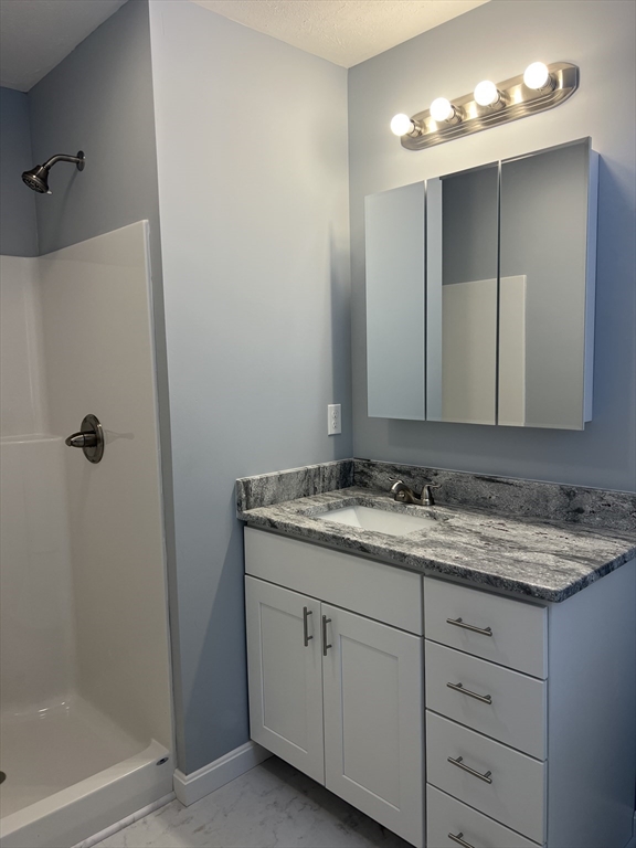 246 Holtshire Road, Unit LOT 3 Orange, MA 01364 - Photo 7 of 16 a bathroom with a granite countertop sink and a mirror