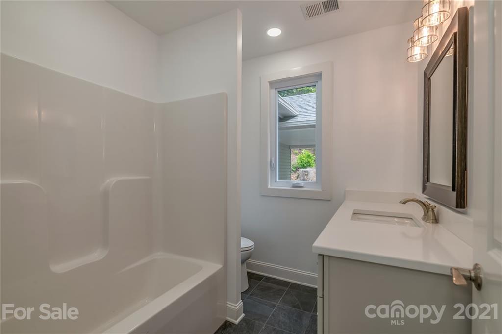555 New Market Road Tryon, NC 28782 - Photo 14 of 37 a bathroom with a sink and a bathtub