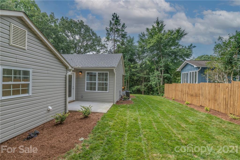 555 New Market Road Tryon, NC 28782 - Photo 3 of 37 a front view of a house with garden