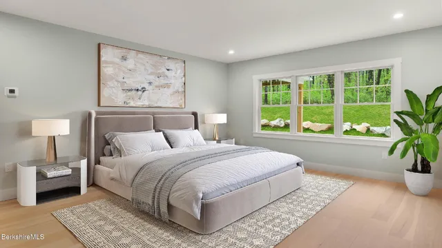 a dining room with furniture and a large window