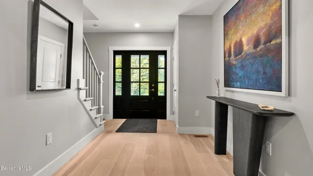 a kitchen with granite countertop white cabinets and sink