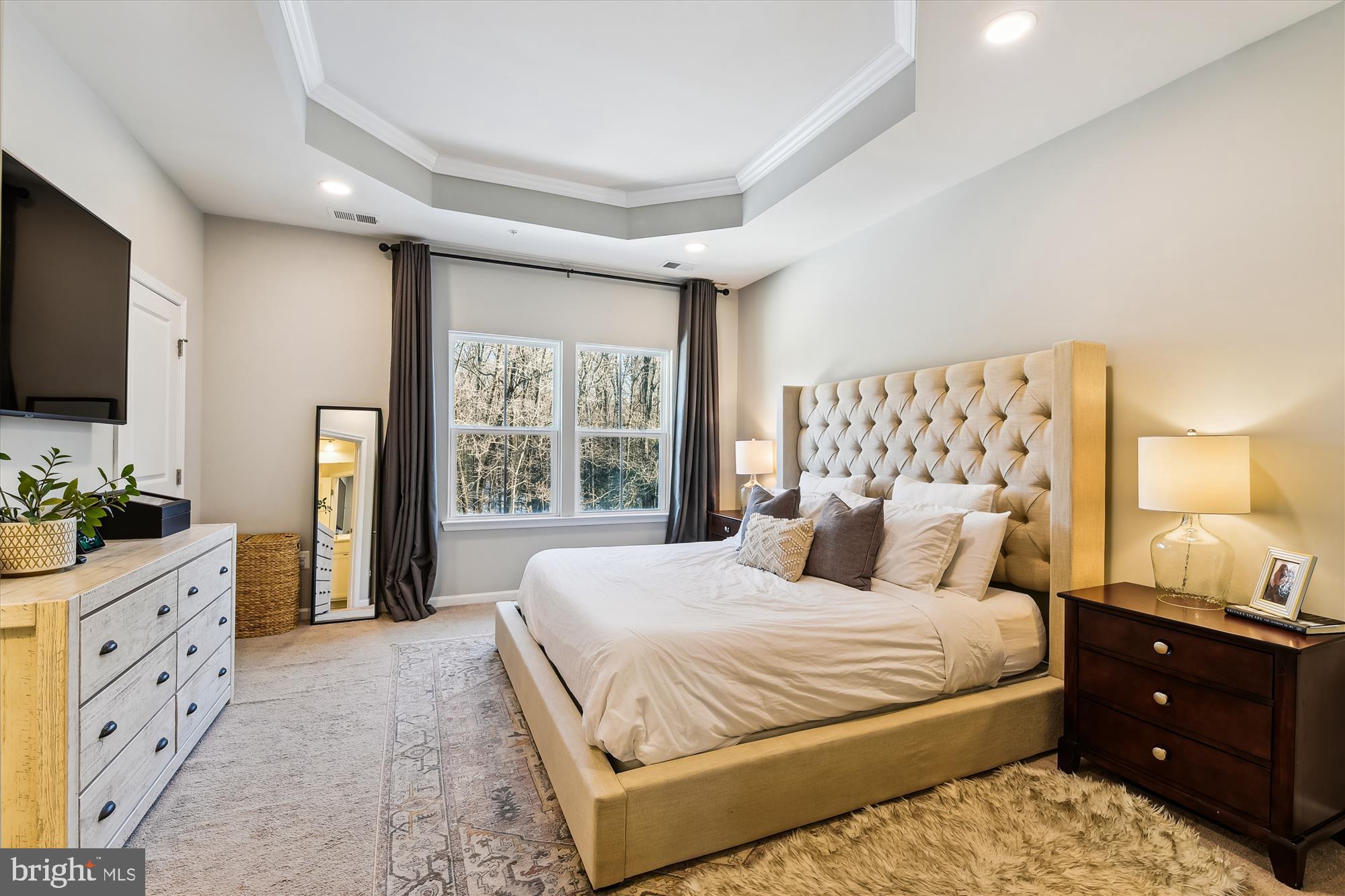 2907 Shaws Road Edgemere, MD 21219 - Photo 17 of 36 a bedroom with a large bed and a flat tv screen on dresser