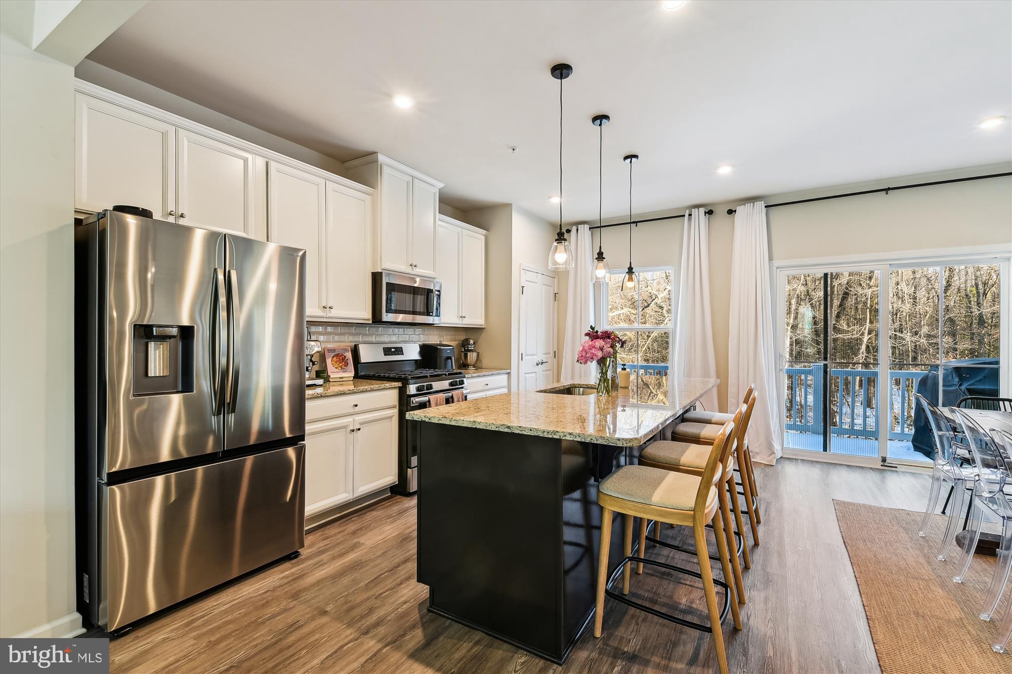 2907 Shaws Road Edgemere, MD 21219 - Photo 4 of 36 a kitchen with stainless steel appliances granite countertop a refrigerator a stove top oven a sink island and a refrigerator