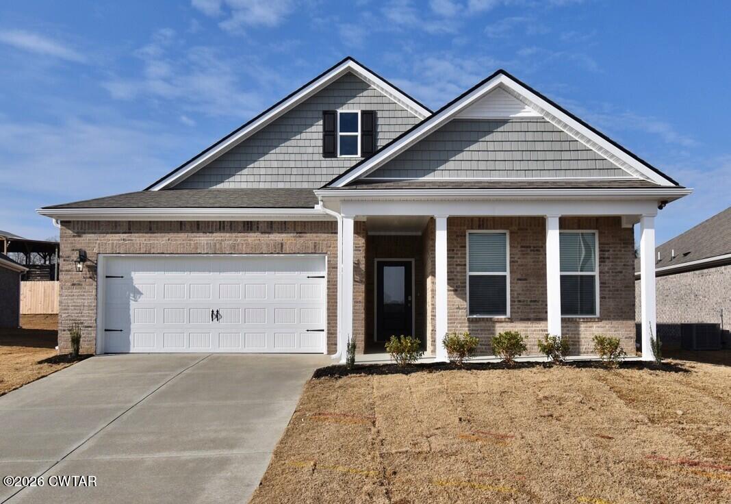 67 Clarendon Cove Jackson, TN 38305 - Photo 1 of 19 a front view of a house with a yard and garage