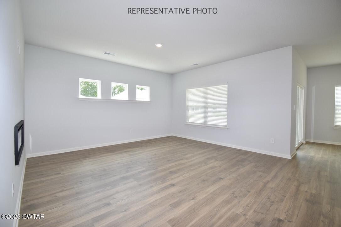 67 Clarendon Cove Jackson, TN 38305 - Photo 3 of 19 a view of an empty room with wooden floor and a window