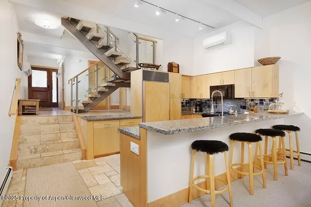 a kitchen with stainless steel appliances kitchen island granite countertop a stove and a sink