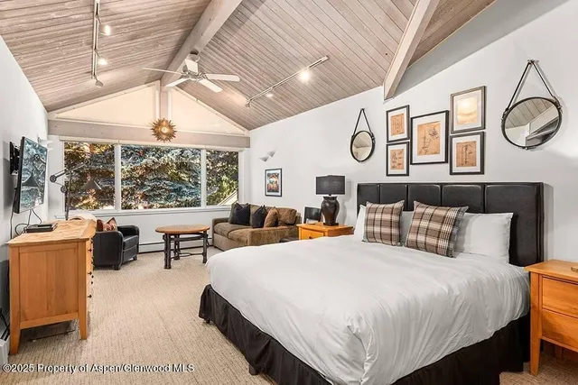 a bedroom with double bed and a large window