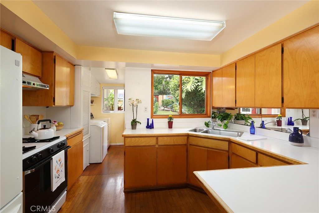 556 Through Street Laguna Beach, CA 92651 - Photo 11 of 30 a kitchen with a sink a stove and cabinets