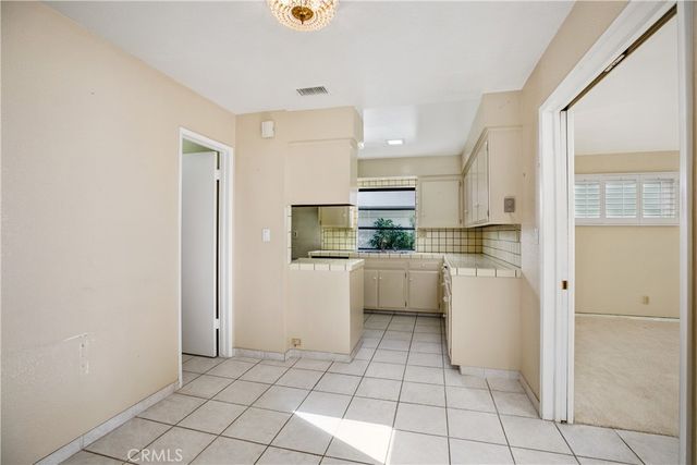 a kitchen with sink cabinets and stove
