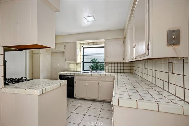 a kitchen with a sink appliances and cabinets