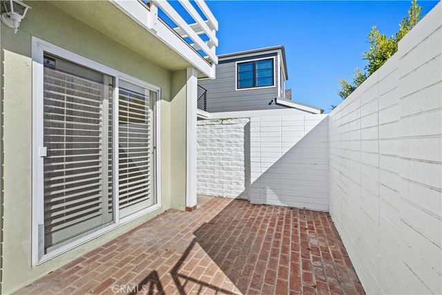 a view of a balcony with wooden floor and fence