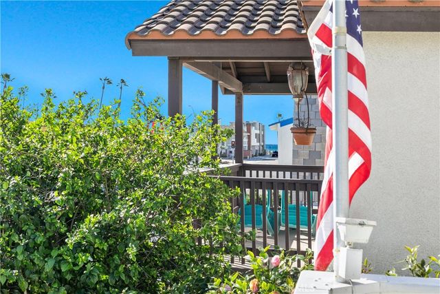 an empty room with a chandelier fan and windows
